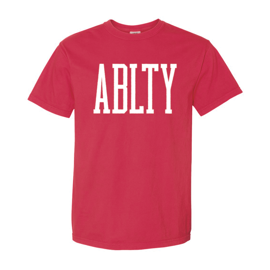 A red tshirt with the word ability in white across the chest